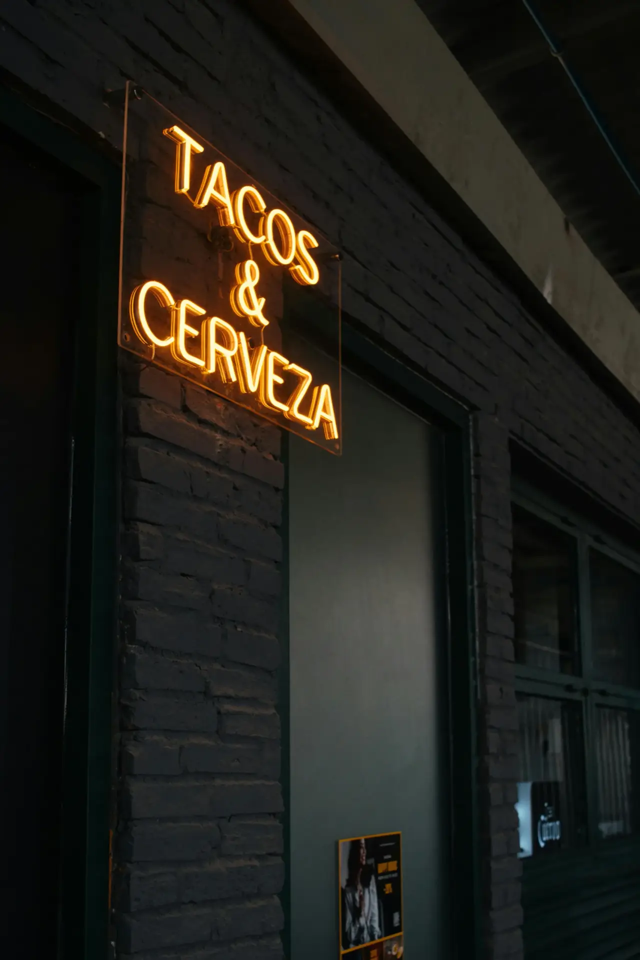 Bright neon sign reading "Tacos and Cerveza" used in branding for Don Cangrejo Bar and Grill, a lively Mexican restaurant and bar in Jacksonville, NC known for authentic tacos and cold beer.